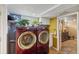 Bright laundry area features modern red appliances and a functional layout near a bathroom at 3242 Utica St, Denver, CO 80212