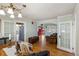 Open floor plan featuring hardwood floors, a red front door, and easy access to kitchen and dining at 3242 Utica St, Denver, CO 80212