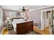 Comfortable bedroom with hardwood floors, neutral walls, a ceiling fan and natural light at 3242 Utica St, Denver, CO 80212