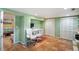 Basement home office with built-in desk, shelving, ample storage, and tile flooring at 3242 Utica St, Denver, CO 80212