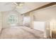 Bright, open loft area with carpet, vaulted ceilings, and natural light from the window at 2980 W Long Dr # E, Littleton, CO 80120