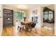Warm dining area with hardwood floors, natural light, and a view of the fireplace at 2980 W Long Dr # E, Littleton, CO 80120