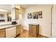 Eat-in kitchen with wood floors, neutral cabinets and granite countertops at 2980 W Long Dr # E, Littleton, CO 80120