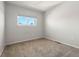 Simple carpeted bedroom with a window offering natural light at 1170 S Troy St, Aurora, CO 80012