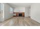 Living room featuring a brick fireplace and access to a backyard patio at 1170 S Troy St, Aurora, CO 80012