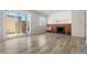 Living room with fireplace, sliding door to patio, and wood-look flooring at 1170 S Troy St, Aurora, CO 80012