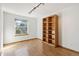 Bright bedroom featuring a large window and a built-in wooden bookshelf at 13755 W Amherst Way, Lakewood, CO 80228