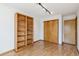 Bedroom with a large window and a built-in bookshelf and closet at 13755 W Amherst Way, Lakewood, CO 80228