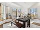 Dining area featuring a spacious table, modern bench, and large bay windows at 13755 W Amherst Way, Lakewood, CO 80228