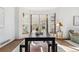 Bright dining area featuring a spacious table, modern bench, and large bay windows at 13755 W Amherst Way, Lakewood, CO 80228