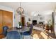 Cozy dining area features a modern chandelier and is adjacent to the living room with a fireplace at 13755 W Amherst Way, Lakewood, CO 80228