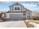 Charming two-story home boasts a two-car garage, brick accents, and a well-manicured front yard at 13755 W Amherst Way, Lakewood, CO 80228