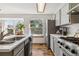 Modern kitchen offers a view to the backyard, stainless steel appliances, and shaker style cabinets at 13755 W Amherst Way, Lakewood, CO 80228