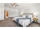 Bright main bedroom with soft carpet, a comfortable bed, and decorative bedside tables at 13755 W Amherst Way, Lakewood, CO 80228