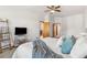 Spacious main bedroom with plush bed, TV on stand, and entry to bath and closet at 13755 W Amherst Way, Lakewood, CO 80228