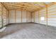 Large barn interior featuring metal walls, wood beams, and a concrete floor at 60600 E 56Th Ave, Strasburg, CO 80136