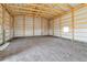 Spacious barn interior with metal siding, wood framing, and a small window for natural light at 60600 E 56Th Ave, Strasburg, CO 80136