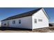 Rear view of a single-story home with white siding and gray accents at 60600 E 56Th Ave, Strasburg, CO 80136