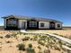 Newly built single-story home featuring black and white color scheme, black shutters, and a concrete path at 60600 E 56Th Ave, Strasburg, CO 80136