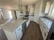 Bright kitchen features an island, stainless steel appliances, granite countertops, and ample cabinet space at 60600 E 56Th Ave, Strasburg, CO 80136