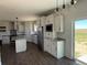 Bright kitchen features an island, stainless steel appliances, granite countertops and ample cabinet space at 60600 E 56Th Ave, Strasburg, CO 80136