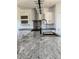 Close up of kitchen showing granite countertops, black appliances, stainless hood and modern lighting at 60600 E 56Th Ave, Strasburg, CO 80136