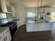 Bright kitchen features an island, stainless steel appliances, granite countertops and ample cabinet space at 60600 E 56Th Ave, Strasburg, CO 80136
