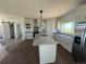 Bright kitchen featuring white cabinets, granite countertops, stainless appliances, and an island at 60600 E 56Th Ave, Strasburg, CO 80136