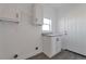 A bright laundry room, featuring modern cabinets, countertops, and a sink for added convenience at 60600 E 56Th Ave, Strasburg, CO 80136