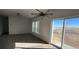 Bright living room with sliding glass doors and carpeting at 60600 E 56Th Ave, Strasburg, CO 80136