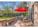 Outdoor patio with red umbrella and a view of the backyard at 2060 Ash St, Denver, CO 80207