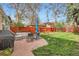 A lovely patio with outdoor furniture overlooks a well-maintained lawn at 2060 Ash St, Denver, CO 80207