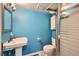 The bathroom features a pedestal sink, white cabinets, and a glass shower door at 2060 Ash St, Denver, CO 80207