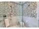 Modern tiled shower with a clear glass shower door and fixtures at 2060 Ash St, Denver, CO 80207