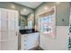 Updated bathroom boasts a vanity, large mirror, and plenty of natural light from the window at 2060 Ash St, Denver, CO 80207