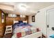 This bedroom features wood paneling, a patchwork quilt, and charming decor at 2060 Ash St, Denver, CO 80207