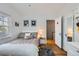 This bedroom offers a cozy feel with natural light, hardwood floors, and a modern closet at 2060 Ash St, Denver, CO 80207