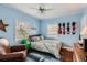 Inviting bedroom with hardwood floors, bright windows, and a ceiling fan for comfort at 2060 Ash St, Denver, CO 80207