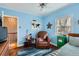 Relaxing blue bedroom with a comfy chair, ceiling fan, and bright window at 2060 Ash St, Denver, CO 80207