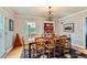 Formal dining room with chandelier, hardwood floors, and a unique hutch at 2060 Ash St, Denver, CO 80207