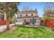 Exterior view of a brick home with a spacious backyard and patio area at 2060 Ash St, Denver, CO 80207