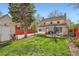 This is a view of the yard, brick home, and patio at 2060 Ash St, Denver, CO 80207