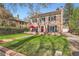 Brick home with manicured lawn and red umbrella at 2060 Ash St, Denver, CO 80207