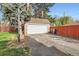 View of the garage and basketball hoop on the driveway at 2060 Ash St, Denver, CO 80207