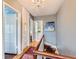 Charming hallway features hardwood floors, a chandelier, and access to multiple rooms at 2060 Ash St, Denver, CO 80207