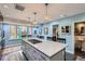 Spacious kitchen with marble island, pendant lighting, and stainless steel appliances at 2060 Ash St, Denver, CO 80207