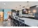 Kitchen with island, cooktop, black cabinetry, and stainless refrigerator at 2060 Ash St, Denver, CO 80207