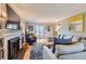 Sunlit living room with a cozy fireplace and lots of seating at 2060 Ash St, Denver, CO 80207