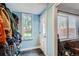 View of the mud room with a window, exterior door, and blue wall at 2060 Ash St, Denver, CO 80207