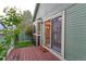 Back porch featuring sliding glass door and mature landscaping at 4877 Darwin Ct, Boulder, CO 80301